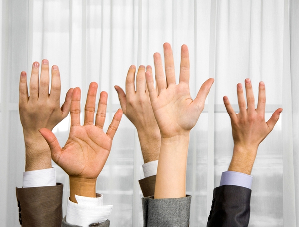 Several people holding their hands up.