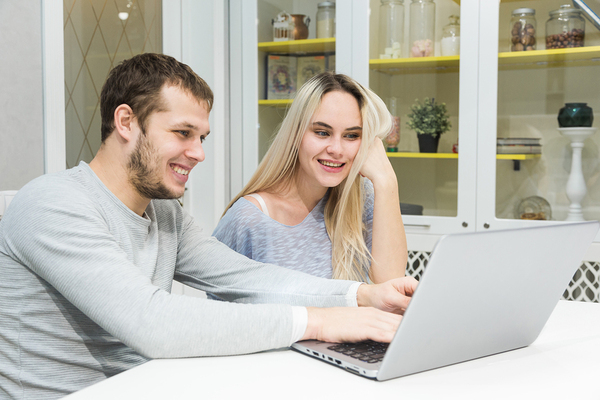 Man and woman working on a laptop.